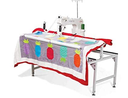 A long arm quilting machine with a quilt on top.