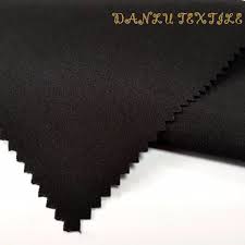 A black fabric suitable for pants featuring the word 'black'.