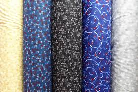 A row of vibrant fabrics with unique patterns perfect for quilt backing.