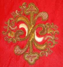 A red cloth with gold embroidery on it.