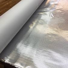 A roll of aluminum foil sitting on top of a table.